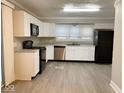 Spacious kitchen featuring white cabinets, stainless steel appliances, and ample counter space at 4943 S State Ave, Indianapolis, IN 46227