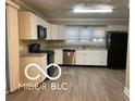 Well-lit kitchen featuring granite countertops, stainless steel appliances, and white cabinets for a clean modern look at 4943 S State Ave, Indianapolis, IN 46227