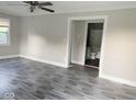 Bright living room boasts new gray flooring and neutral paint palette at 4943 S State Ave, Indianapolis, IN 46227