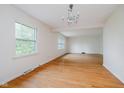 Bright living room featuring hardwood floors, two large windows, and neutral walls at 530 Westmore Dr, Indianapolis, IN 46214