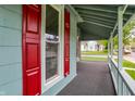 Covered porch with crisp white railing and red shutters, offering a relaxing outdoor space at 538 N East St, Greenfield, IN 46140