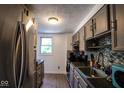 Efficient kitchen features stainless steel refrigerator and granite countertops with tile backsplash at 5522 Closser Ct, Indianapolis, IN 46221