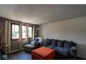 Comfortable living room features multiple windows, hardwood floors, and modern decor at 5522 Closser Ct, Indianapolis, IN 46221