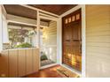 Cozy front porch with a wood door, 'welcome' mat, and screen door that opens to an interior living space at 5622 Guilford Ave, Indianapolis, IN 46220