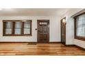 Spacious living room with hardwood floors, natural light, and traditional wood trim and moldings around windows at 5622 Guilford Ave, Indianapolis, IN 46220