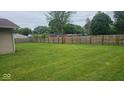 Large, well-manicured backyard with a tall wooden fence providing privacy to the property at 5805 S Gale St, Indianapolis, IN 46227