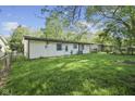 Spacious backyard showcasing the home's exterior and lush lawn at 611 Hampton Ln, Anderson, IN 46017