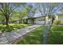 A charming single-story home with an attached garage and a concrete driveway at 611 Hampton Ln, Anderson, IN 46017