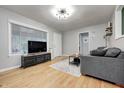 Bright living room with hardwood floors, a large window, and modern furnishings at 752 N Leland Ave, Indianapolis, IN 46219