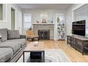 Cozy living room featuring a fireplace, hardwood floors, and comfortable seating at 752 N Leland Ave, Indianapolis, IN 46219