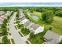 Scenic aerial view of a neighborhood with a pond and lush greenery at 7559 Pipestone Dr, Indianapolis, IN 46217