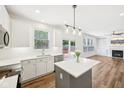 Modern kitchen featuring white cabinets, stainless steel appliances, an island, and an open floor plan at 764 Bloor Woods Ct, Zionsville, IN 46077