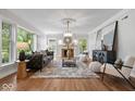 Bright living room features hardwood floors, large windows, and modern furnishings at 8100 N Meridian St, Indianapolis, IN 46260