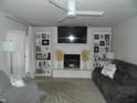 Inviting living room with a cozy fireplace, custom bookcases, and neutral decor at 833 N 700 W, Greenfield, IN 46140