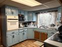 Functional kitchen with blue cabinetry, a built-in oven, and ample counter space at 909 Sullivan St, Alexandria, IN 46001