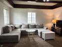 Spacious living room featuring a large sectional sofa and natural light from a window at 909 Sullivan St, Alexandria, IN 46001