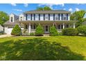 Charming two-story home featuring a welcoming covered front porch and beautifully landscaped yard at 10172 Watkins Ct, Indianapolis, IN 46234