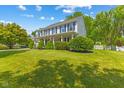 Inviting two-story home featuring a spacious lawn and a classic white picket fence and covered porch at 10172 Watkins Ct, Indianapolis, IN 46234