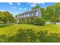 Inviting two-story home featuring a spacious lawn and a classic white picket fence and covered porch at 10172 Watkins Ct, Indianapolis, IN 46234