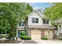 Attractive two-story home featuring a two-car garage, brick accents, and mature trees at 1030 Longwell Pl, Indianapolis, IN 46240