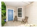 Inviting front porch with seating, a blue door, and ample natural light at 1030 Longwell Pl, Indianapolis, IN 46240
