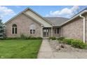 Inviting front entrance featuring a walkway, meticulous landscaping, and a cozy porch area at 105 Meadowview Ln, Greenwood, IN 46142