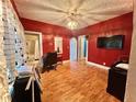 Bedroom featuring bold red walls, hardwood floors, and bright overhead lighting at 1332 W 26Th St, Indianapolis, IN 46208