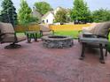 Cozy stone fire pit surrounded by comfortable seating, creating a relaxing outdoor gathering space at 13497 Dunes Dr, Carmel, IN 46032