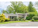 Lovely single-story home with a charming exterior and mature trees surrounding the property at 140 Meridian Hills Blvd, Indianapolis, IN 46260