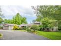 Beautiful home with a spacious driveway, detached garage and well-manicured landscaping at 140 Meridian Hills Blvd, Indianapolis, IN 46260