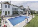This backyard features a pristine pool, stone patio, and seamless indoor-outdoor living at 14464 Gainesway Cir, Fishers, IN 46040