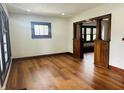 Bright living room with hardwood floors, natural light, and decorative dark wood trim at 1718 Thaddeus St, Indianapolis, IN 46203
