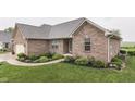 A beautiful brick home with professional landscaping and a well-maintained lawn, offering great curb appeal at 1751 S Centennial Ave, New Palestine, IN 46163