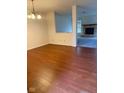 Bright dining room featuring gleaming hardwood floors and views of a fireplace at 1774 Blue Grass Pkwy, Greenwood, IN 46143