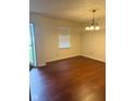 Cozy dining area with hardwood floors and a view of the front yard through a window at 1774 Blue Grass Pkwy, Greenwood, IN 46143