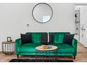Living room featuring green velvet sofa, stylish decor, and modern accents at 1837 S East St, Indianapolis, IN 46225