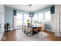 Elegant dining room with a long table, stylish chairs, and ample natural light from large windows at 19848 Chatsworth Blvd, Westfield, IN 46074