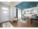 Stylish living room featuring wood floors, a modern light fixture, and a cozy seating area with an accent-colored ceiling at 19848 Chatsworth Blvd, Westfield, IN 46074