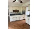Functional kitchen with white cabinetry, blue countertops, stainless steel appliances, and a vinyl floor at 2026 S Q St, Elwood, IN 46036
