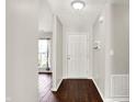 Inviting entryway with hardwood floors, a white front door, and a decorative shelf and coat rack at 2201 Schoolmarm Dr, Greenfield, IN 46140