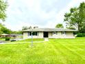 Charming single-story home on a well-manicured front lawn at 2221 E 35Th St, Anderson, IN 46013