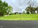 Beautiful single-story home sits atop a well-manicured, sloping front lawn at 2221 E 35Th St, Anderson, IN 46013