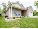 Well-maintained house with lush lawn and cozy front porch seating at 2686 Lafayette Ave, Columbus, IN 47201