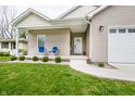 Close-up of charming front porch with seating and manicured landscaping at 2686 Lafayette Ave, Columbus, IN 47201
