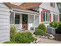 Inviting front porch area with seating, trimmed bushes, and direct access to the front entrance at 2929 E 62Nd St, Indianapolis, IN 46220