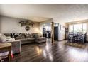 Cozy living room with wood floors and comfortable seating, seamlessly connected to the kitchen at 2965 E 1100 N, Pendleton, IN 46064