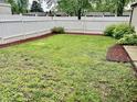 Green backyard with new mulch and a privacy fence, perfect for outdoor activities and relaxation at 3645 Winings Ave, Indianapolis, IN 46221