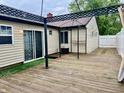 Wooden deck featuring a pergola and sliding glass door with backyard access at 3645 Winings Ave, Indianapolis, IN 46221