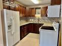 Well-lit kitchen with lots of storage cabinets, modern appliances, and beautiful tiled backsplash at 3645 Winings Ave, Indianapolis, IN 46221
