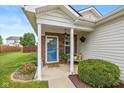 Inviting front porch with hanging flowers, decor, and brick accents creating a warm welcome at 4256 Zachary Ln, Westfield, IN 46062